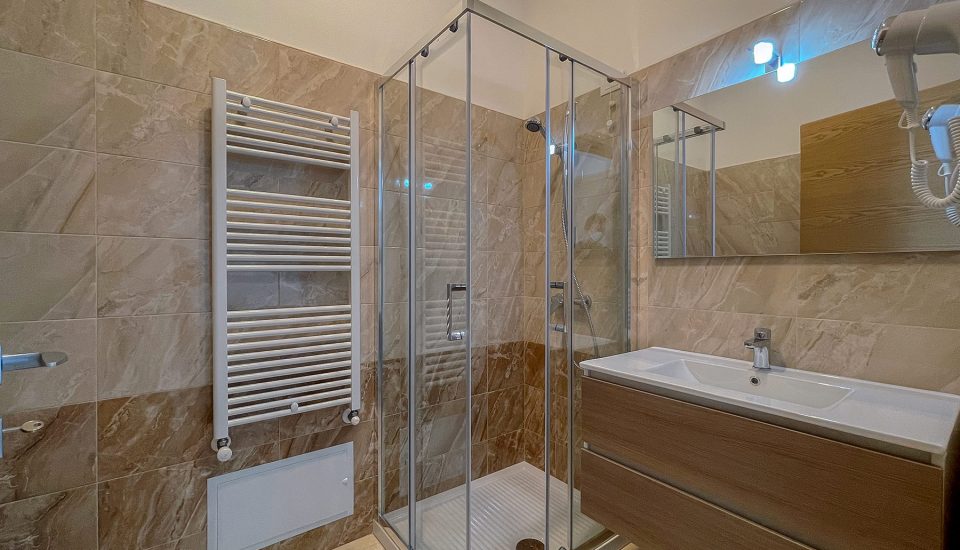 bagno con lavandino e doccia sullo sfondo del Karpignàna Hotel